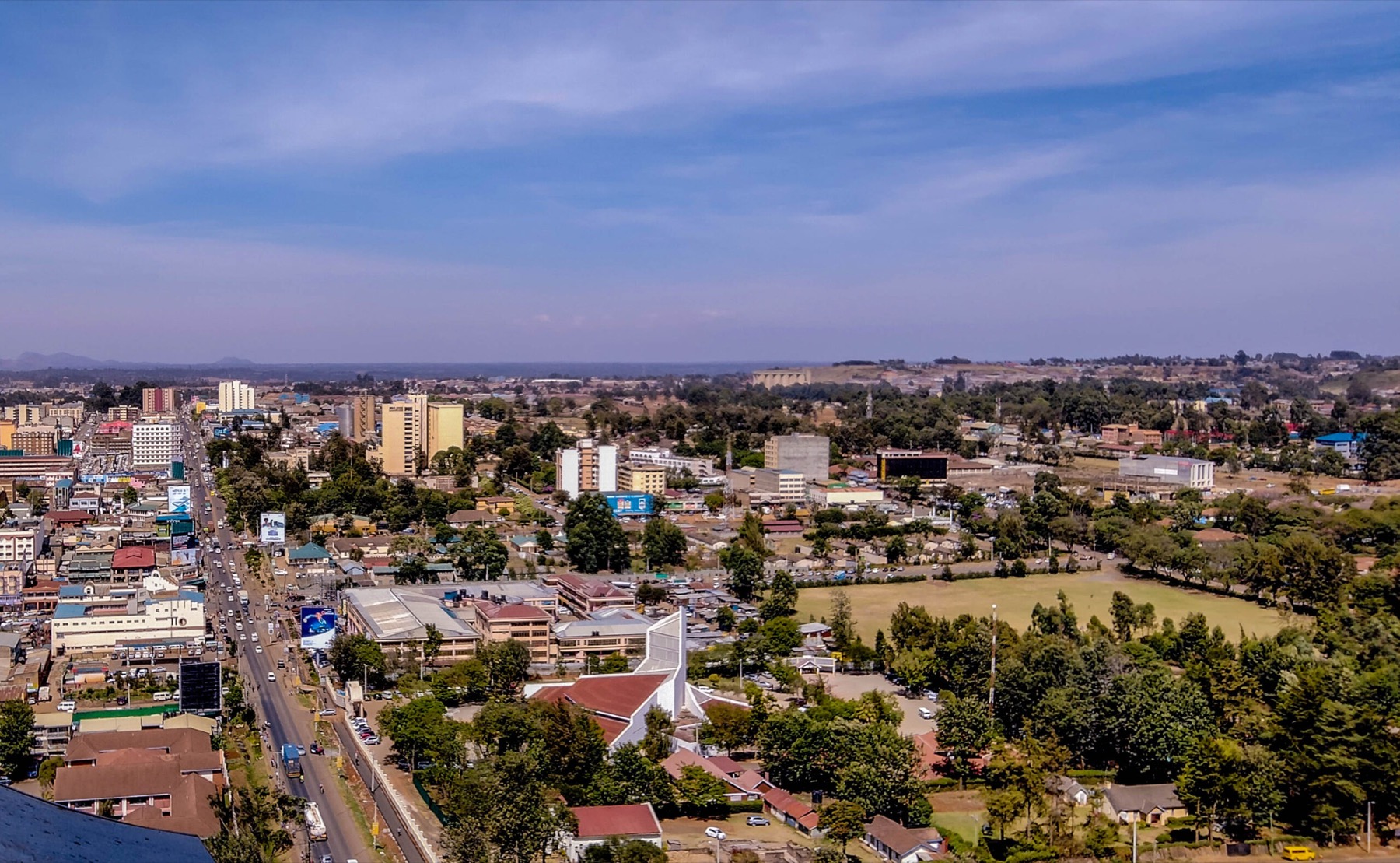 Building a liveable, inclusive future. City activity, connected roads, and established green spaces form the setting for inclusive urban development.